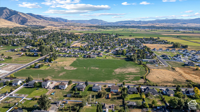 294 West 3400 South, Unit 9 Logan, UT 84321 - Photo 7 of 24 Aerial overview of property's location with a mountain backdrop and nearby suburban area