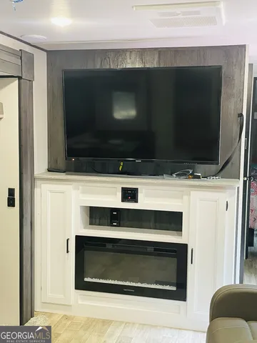 a living room with a fireplace and a flat screen tv