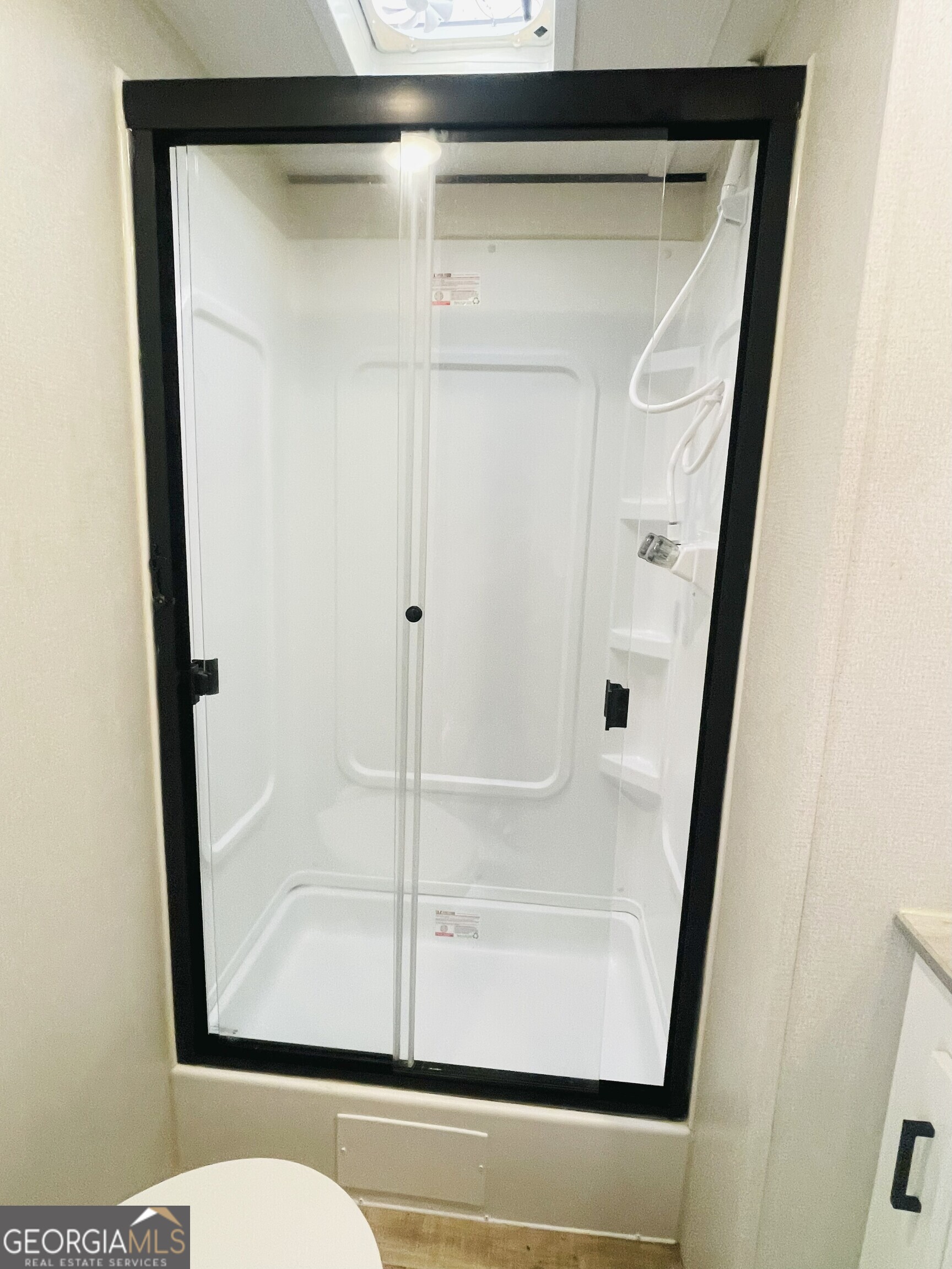 95 Hillcrest Court Cleveland, GA 30528 - Photo 20 of 26 a bathroom with a glass shower door