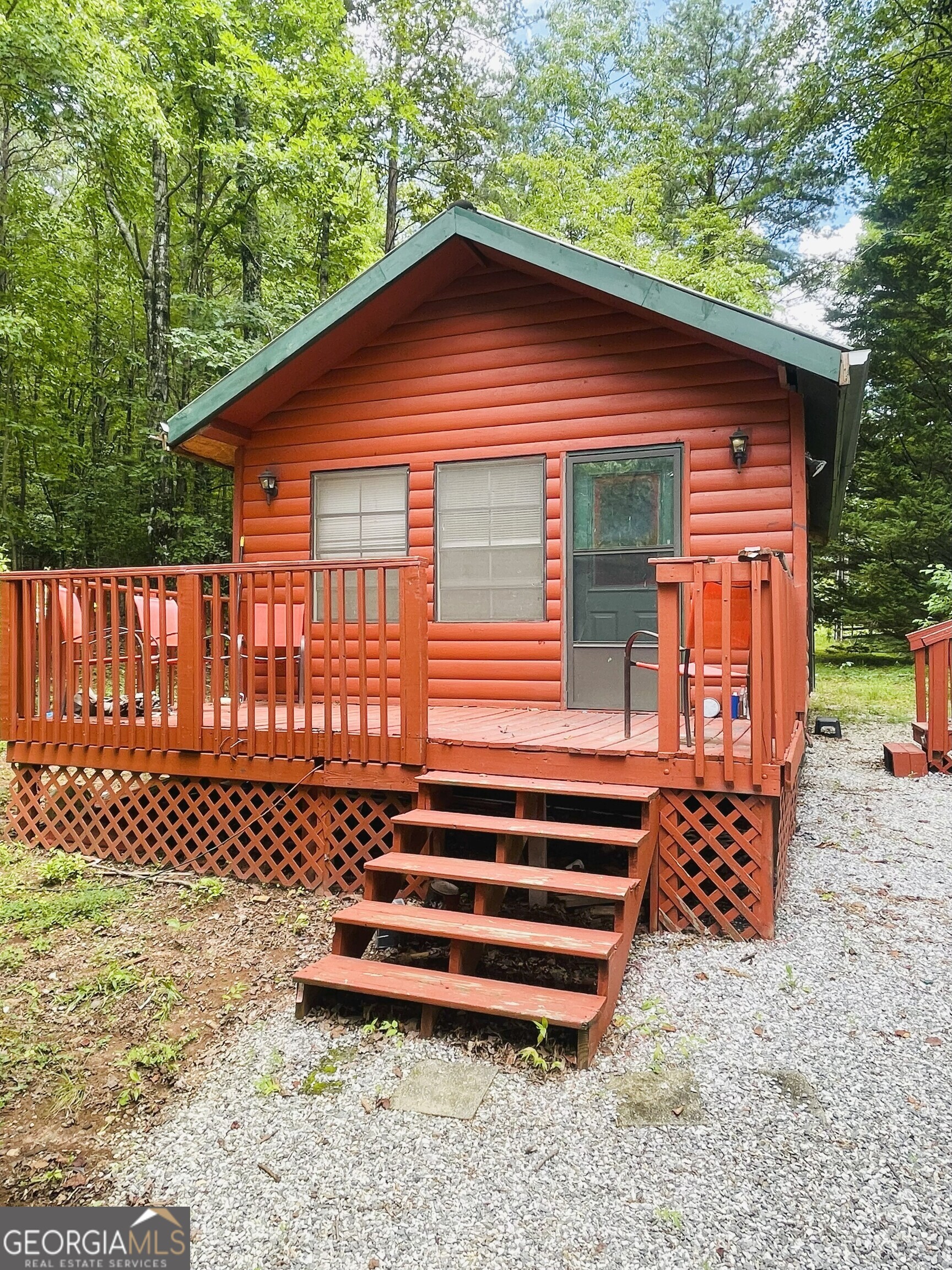 95 Hillcrest Court Cleveland, GA 30528 - Photo 3 of 26 a backyard of a house with wooden fence and large trees