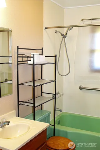 a bathroom with a sink a mirror and a shower