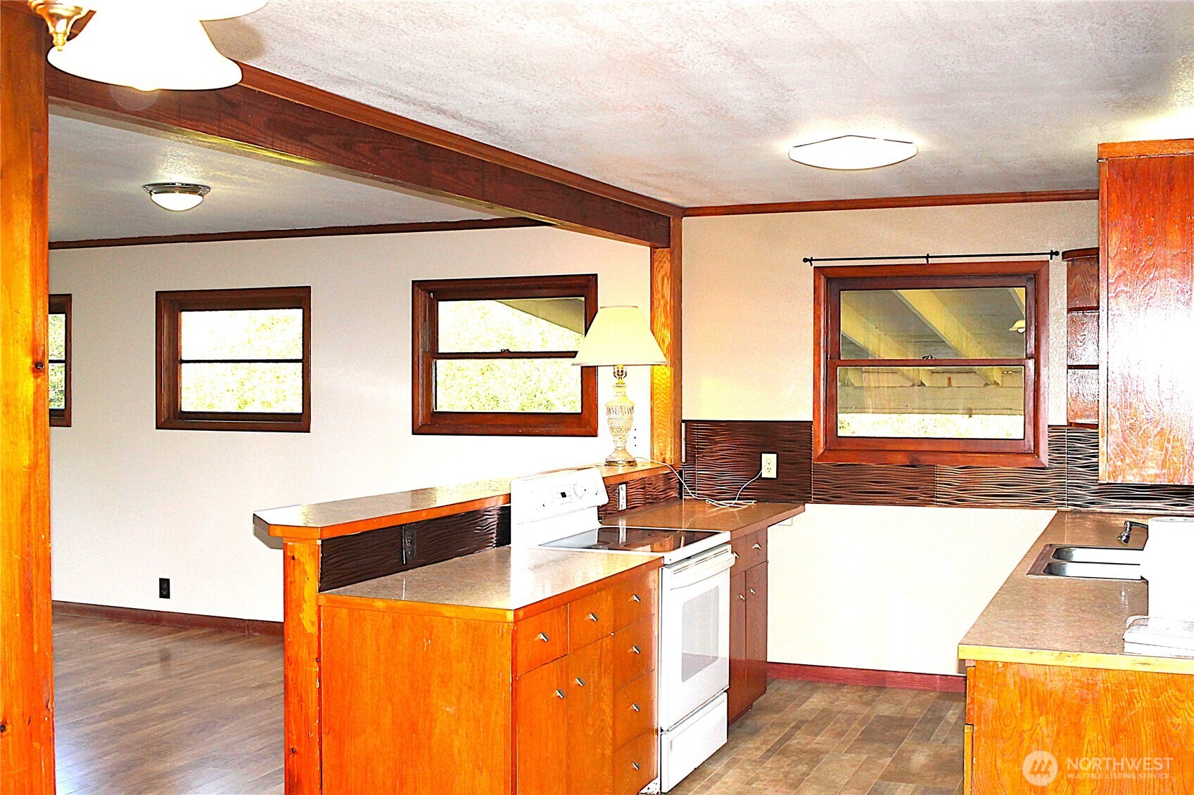 2621 Tokeland Road Tokeland, WA 98590 - Photo 8 of 38 a kitchen with stainless steel appliances kitchen island granite countertop a sink and a wooden cabinets