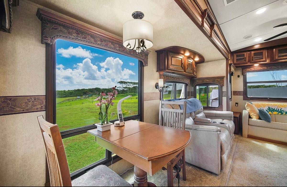 St, Unit 3C Kapaa, HI 96746 - Photo 6 of 25 a view of a dining room with furniture a chandelier and a large window