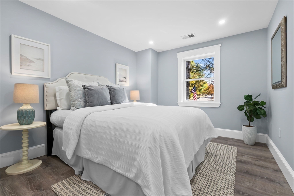 106 Hull Street Beverly, MA 01915 - Photo 11 of 34 a bedroom with a bed and painting on the wall