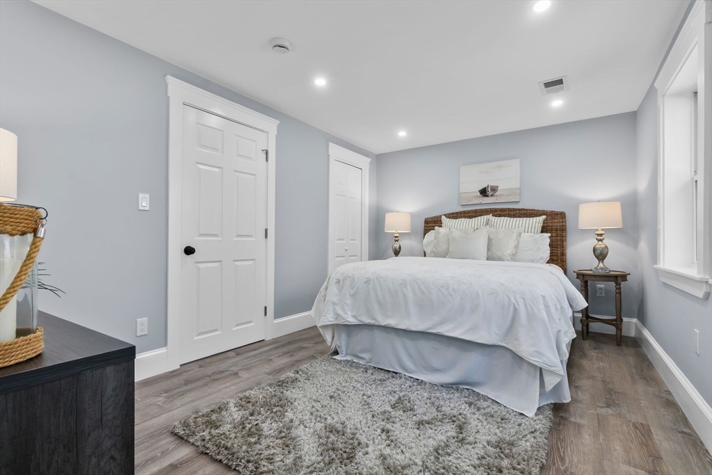 106 Hull Street Beverly, MA 01915 - Photo 12 of 34 a bedroom with a bed and wooden floor