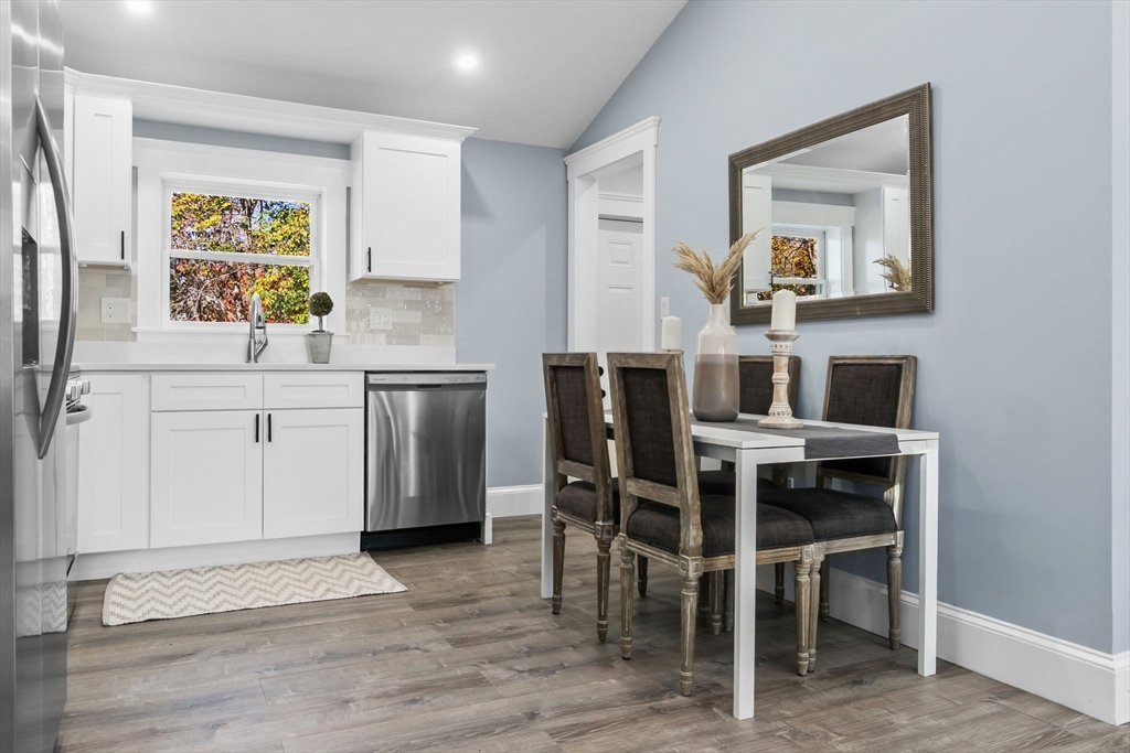 106 Hull Street Beverly, MA 01915 - Photo 3 of 34 a kitchen with a dining table chairs and refrigerator