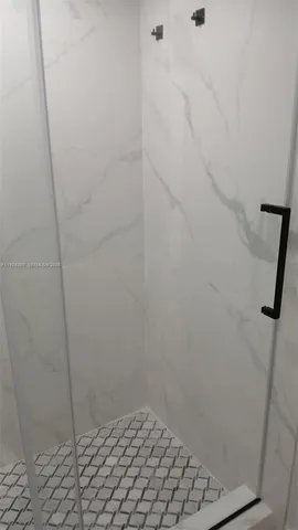 a room with cabinet and mirror