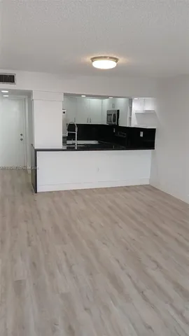 a view of a room with wooden floor and outdoor view