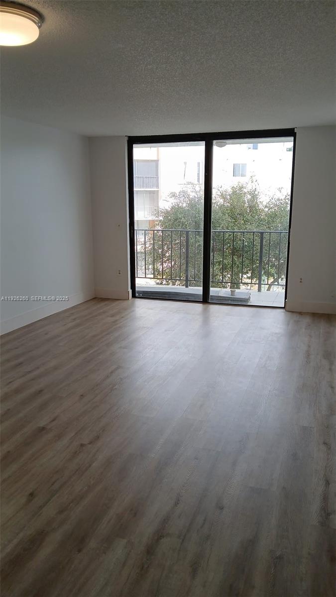 9682 Fontainebleau Boulevard, Unit 312 Miami, FL 33172 - Photo 24 of 33 a view of a room with wooden floor and outdoor view