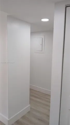 a kitchen with a refrigerator and a sink