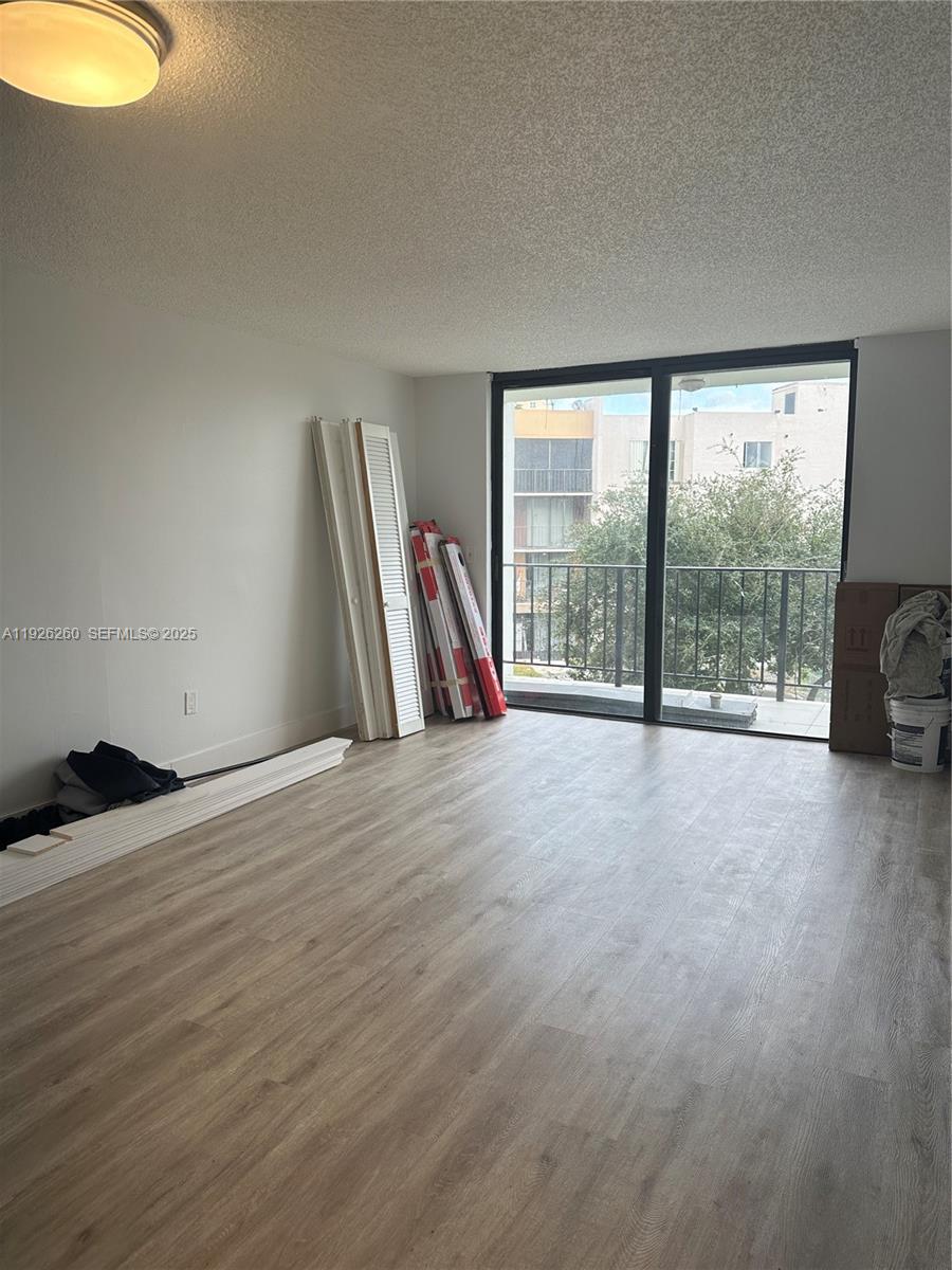 9682 Fontainebleau Boulevard, Unit 312 Miami, FL 33172 - Photo 29 of 33 a view of a room with wooden floor and a sink