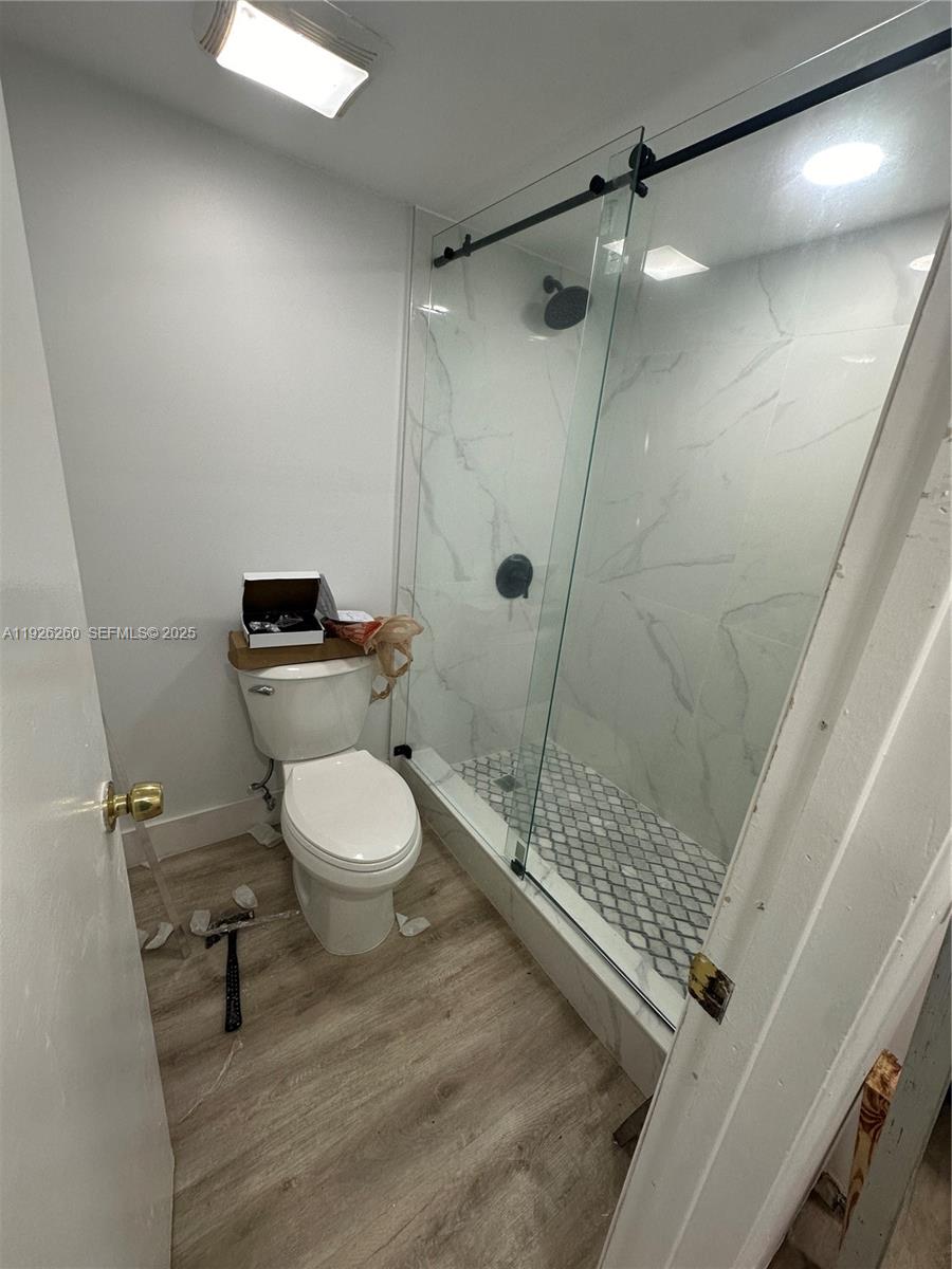 9682 Fontainebleau Boulevard, Unit 312 Miami, FL 33172 - Photo 31 of 33 a bathroom with a toilet and a shower