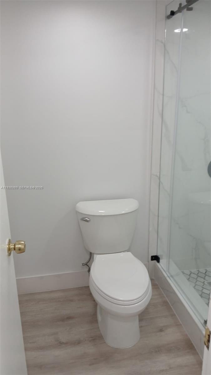 9682 Fontainebleau Boulevard, Unit 312 Miami, FL 33172 - Photo 10 of 33 a white toilet sitting next to a shower