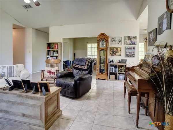 a living room with furniture and a bookshelf
