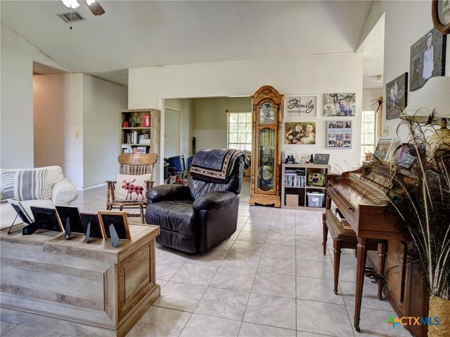 a living room with furniture and a bookshelf
