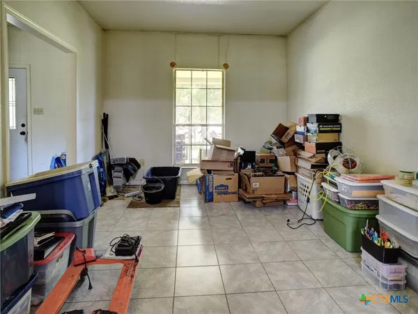 a room with furniture a flat screen tv and a window