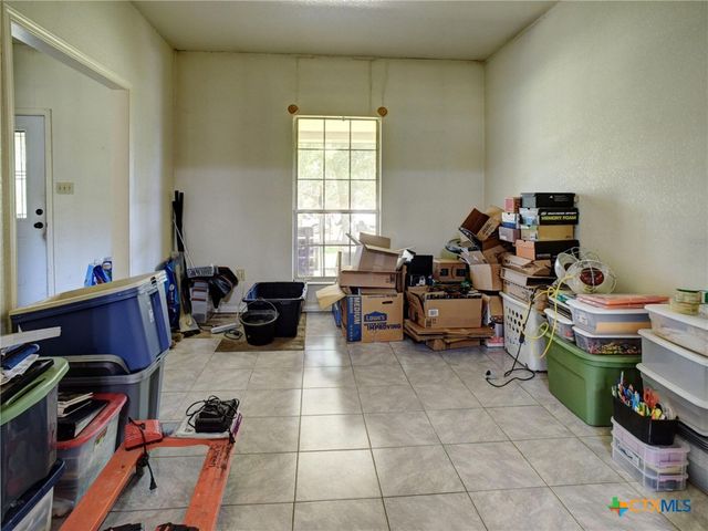 a room with furniture a flat screen tv and a window