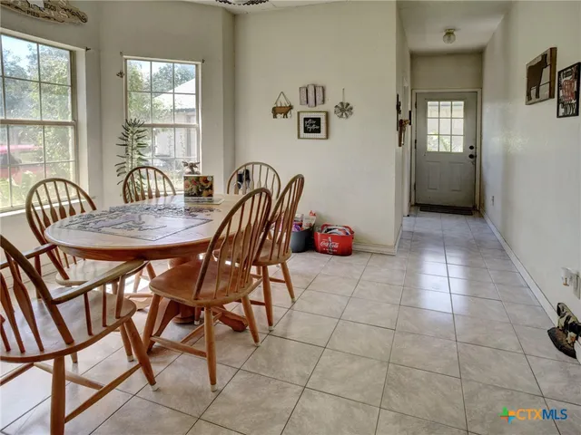 a dining room with furniture and window