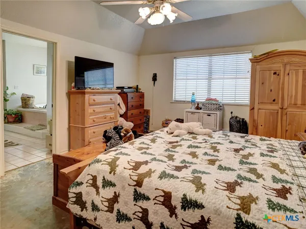 a bed room with a bed and a television