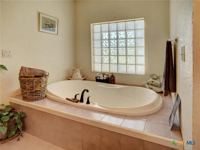 a bathroom with a tub and a window
