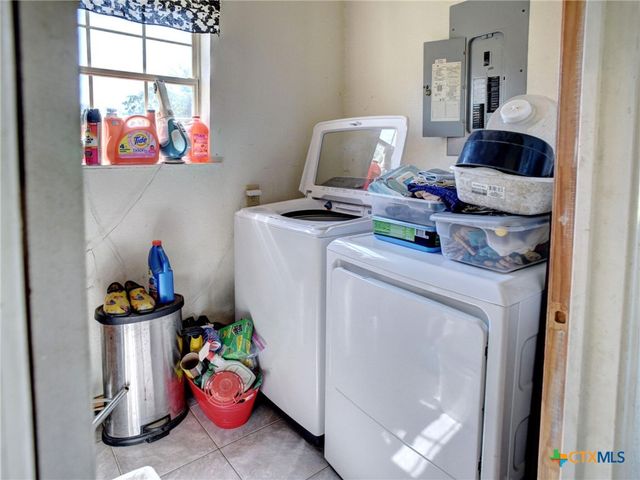 a room with furniture a rug and a fireplace