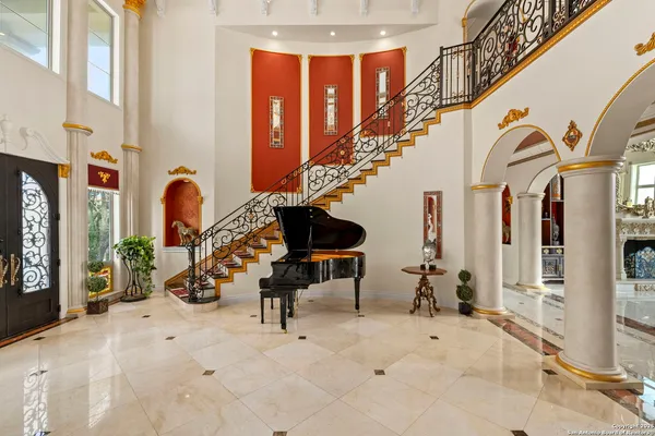 a view of a dining room with furniture and chandelier