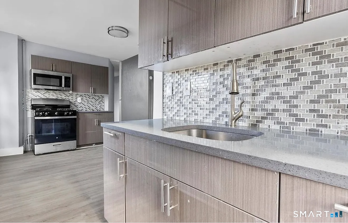 a kitchen with a sink cabinets and stainless steel appliances