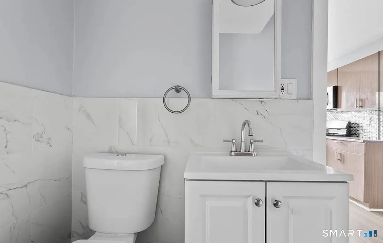 748 Maple Street, Unit 3 Bridgeport, CT 06608 - Photo 11 of 13 a bathroom with a sink a toilet and vanity