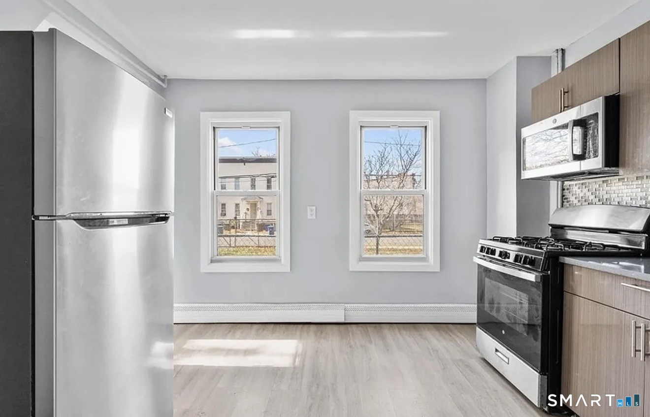 748 Maple Street, Unit 3 Bridgeport, CT 06608 - Photo 2 of 13 a kitchen with stainless steel appliances a stove a microwave and a refrigerator