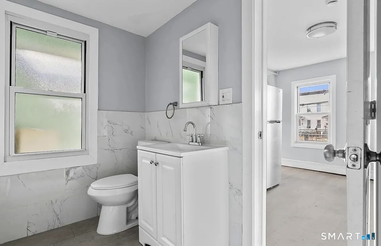 748 Maple Street, Unit 3 Bridgeport, CT 06608 - Photo 9 of 13 a bathroom with a sink toilet and vanity