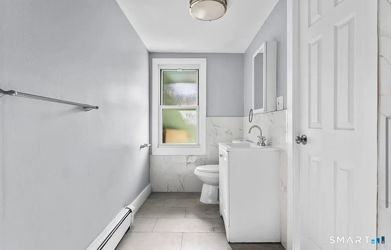 748 Maple Street, Unit 3 Bridgeport, CT 06608 - Photo 10 of 13 a bathroom with a sink toilet and shower