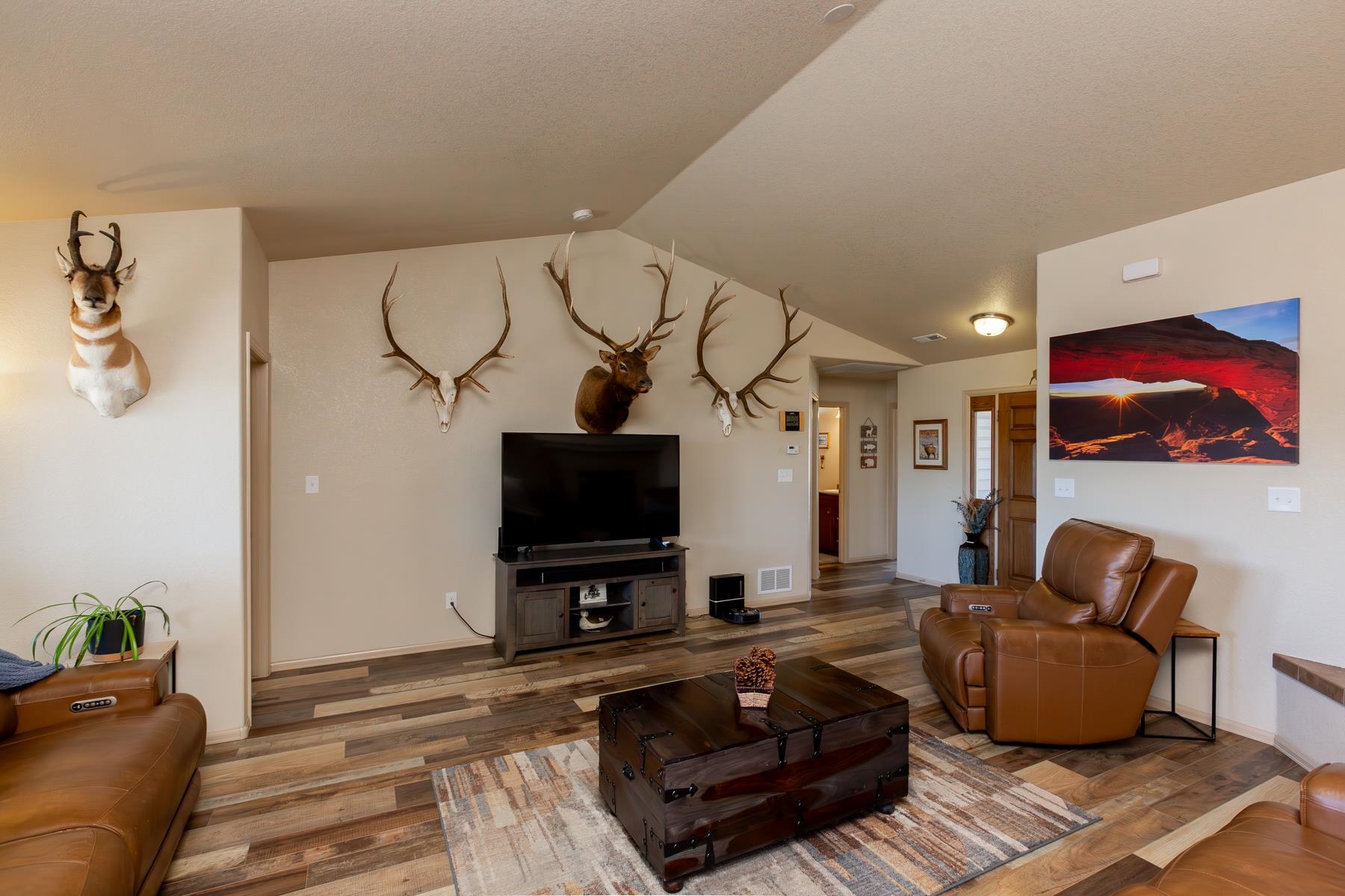 103 Red Rocks Street Fruita, CO 81521 - Photo 21 of 39 a living room with furniture and a flat screen tv