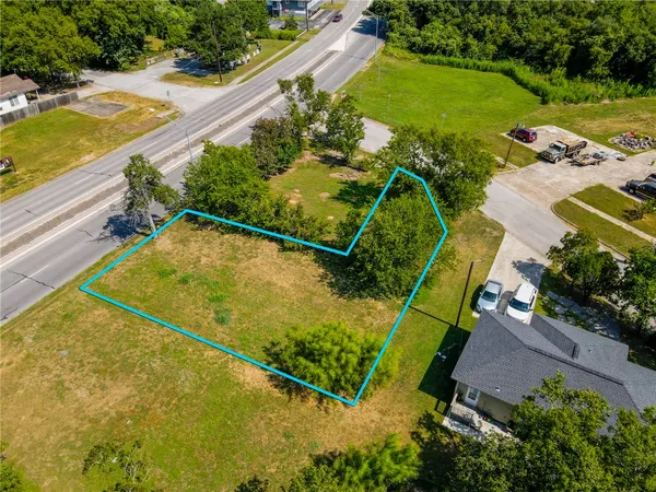 an aerial view of a residential houses with outdoor space and swimming pool