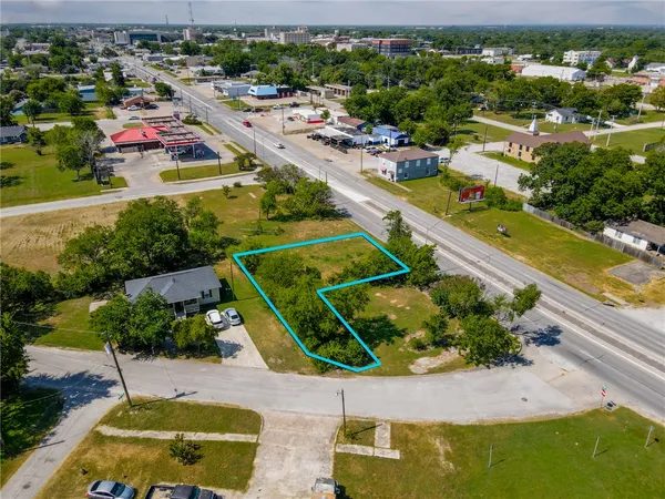an aerial view of a house with a swimming pool outdoor seating and yard