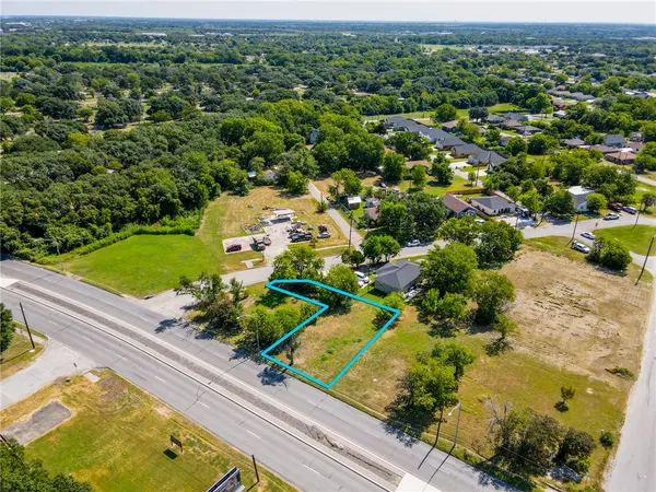 an aerial view of a houses with a yard