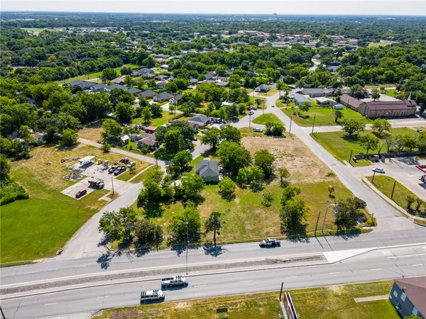 an aerial view of residential houses with outdoor space and swimming pool