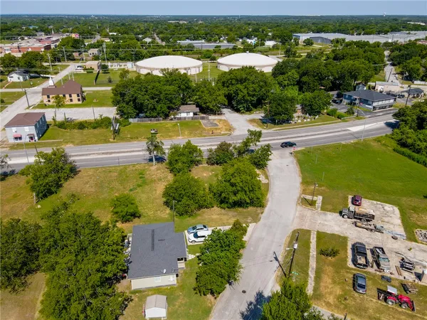 an aerial view of residential houses with outdoor space and river view