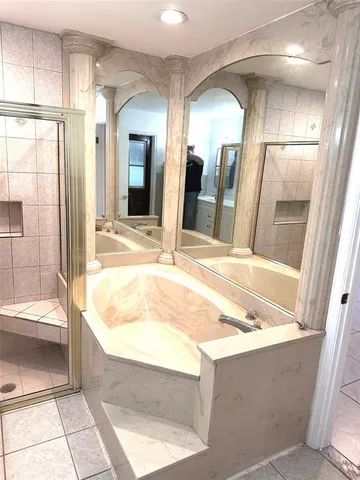 a bathroom with a tub and shower