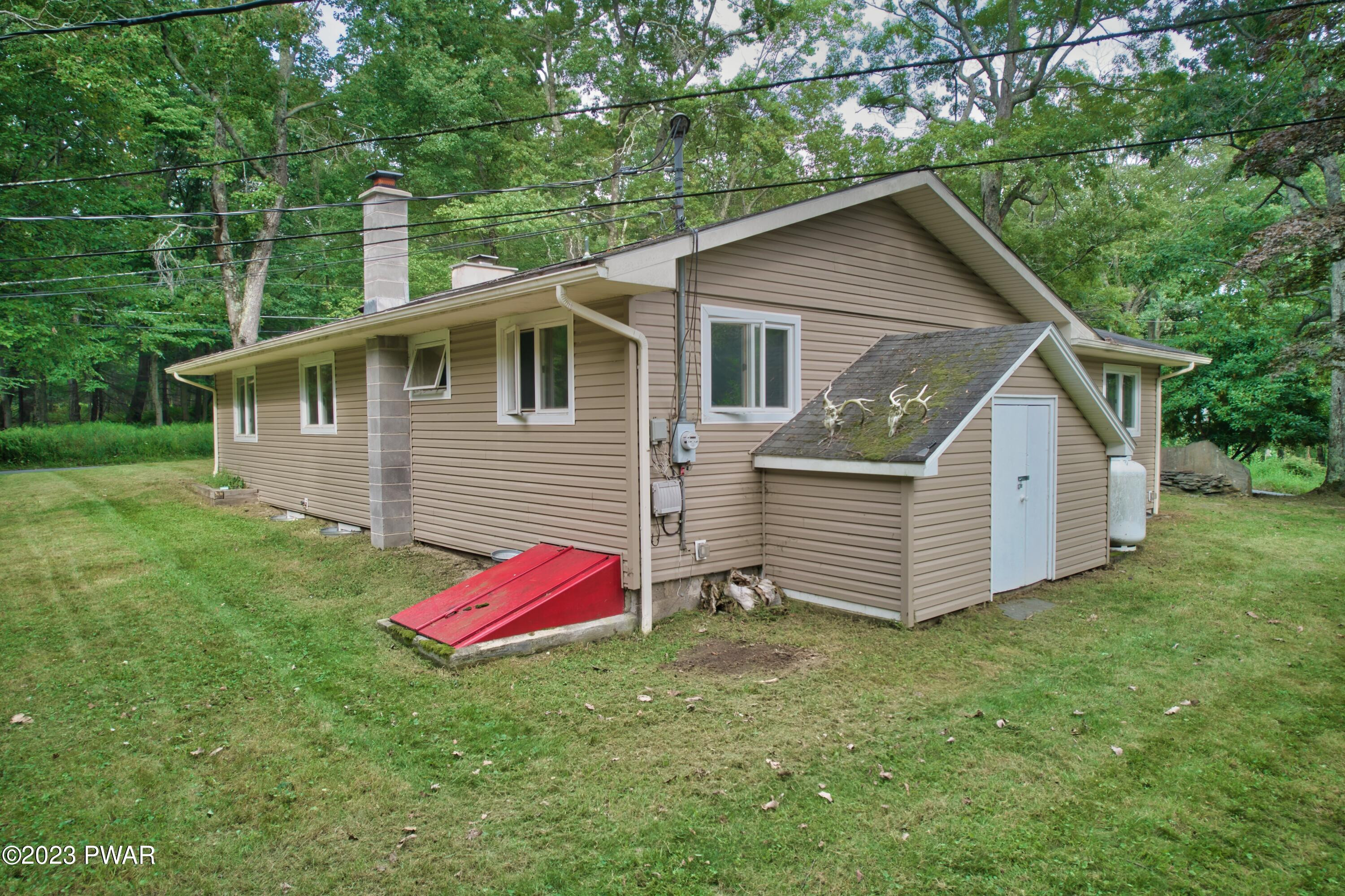 149 Walker Lake Road Shohola, PA 18458 - Photo 39 of 51 a front view of a house with yard