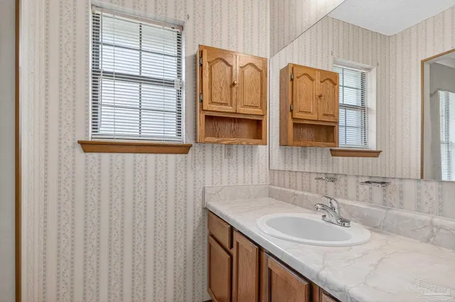 a bathroom with 2 sink and a mirror