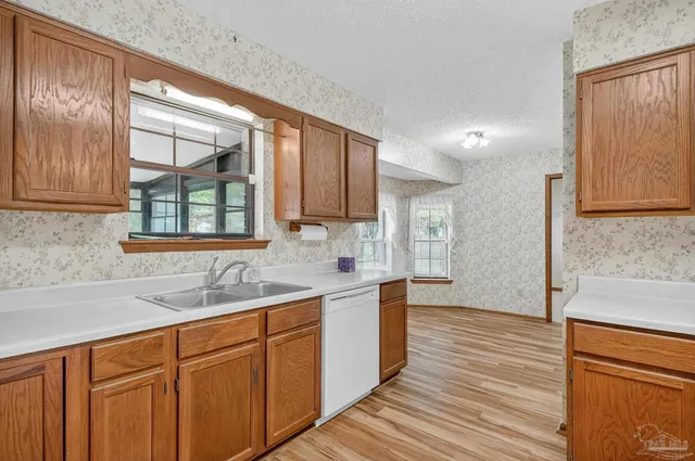 a kitchen with a sink cabinets and window