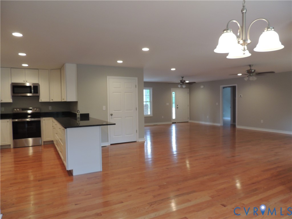 4417 Olgers Road Sutherland, VA 23885 - Photo 8 of 24 Open-concept living area featuring wood-finish flo