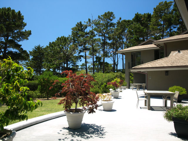 1504 Viscaino Road Pebble Beach, CA 93953 - Photo 4 of 20 a view of a patio with table and chairs potted plants with sky view