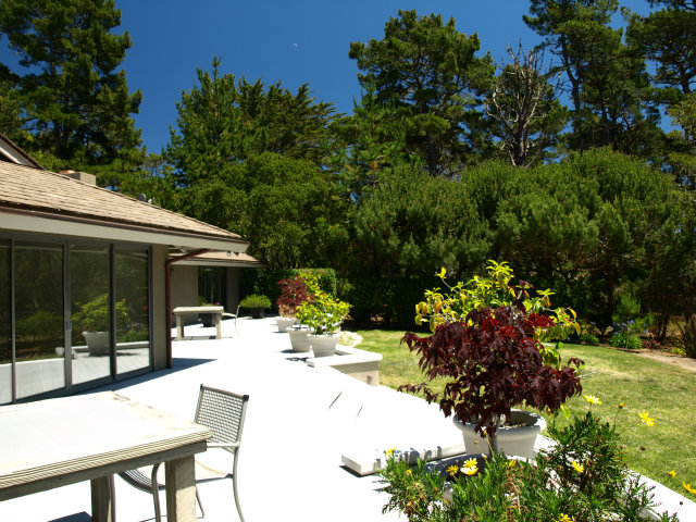 1504 Viscaino Road Pebble Beach, CA 93953 - Photo 9 of 20 a view of a patio with table and chairs and potted plants