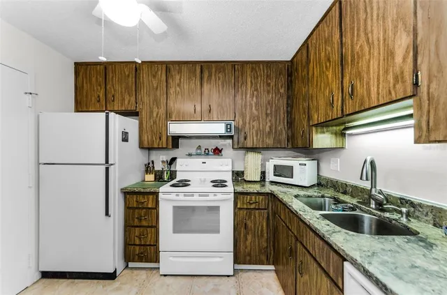 a kitchen with a stove sink and refrigerator
