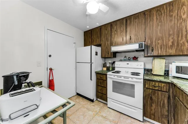 a kitchen with a stove and a refrigerator