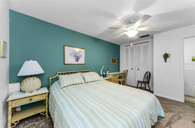 a bedroom with a bed and a lamp