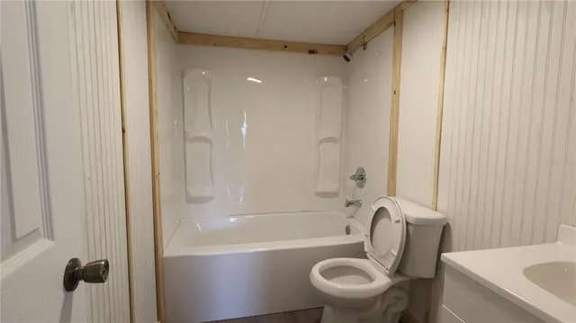 a bathroom with a toilet a sink and bathtub