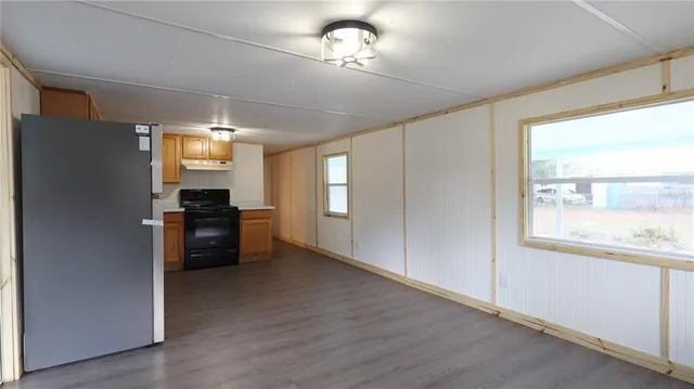a kitchen with granite countertop a refrigerator and a stove