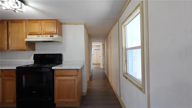 a kitchen with a refrigerator and cabinets